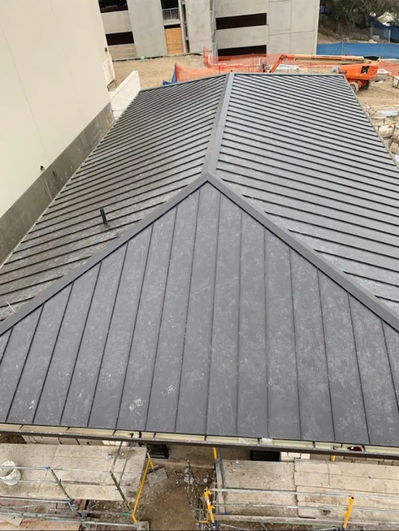 Commercial metal roof construction with crane equipment in Flagstaff