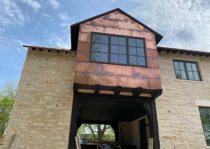 Copper metal panel facade on a stone building for Roof Repair in Flagstaff
