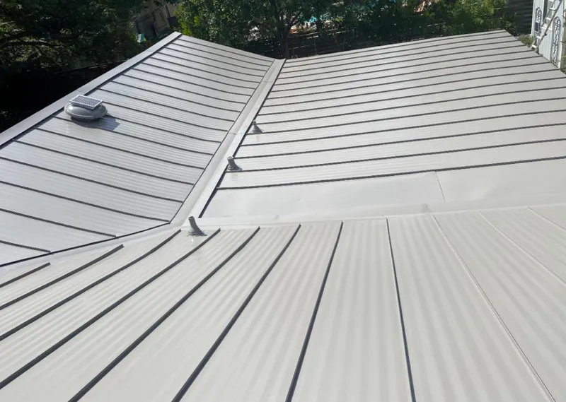 Solar attic fan installed on a metal roof for Roof Ventilation in Flagstaff